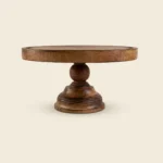Round mango wood cake stand in walnut finish with a ball-shaped stem and a wide pedestal base, on a white background