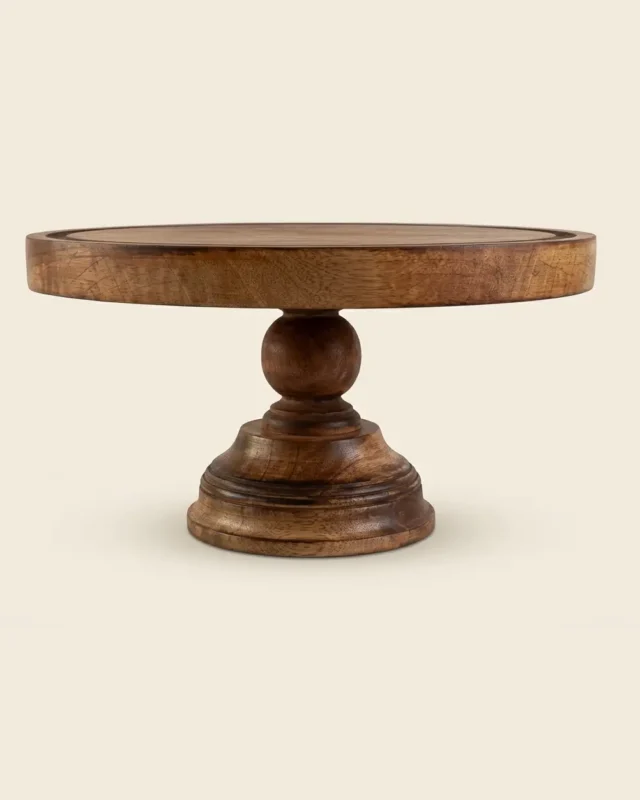 Round mango wood cake stand in walnut finish with a ball-shaped stem and a wide pedestal base, on a white background